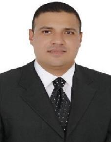 A person wearing a suit and tie smiling at the camera
Description automatically generated